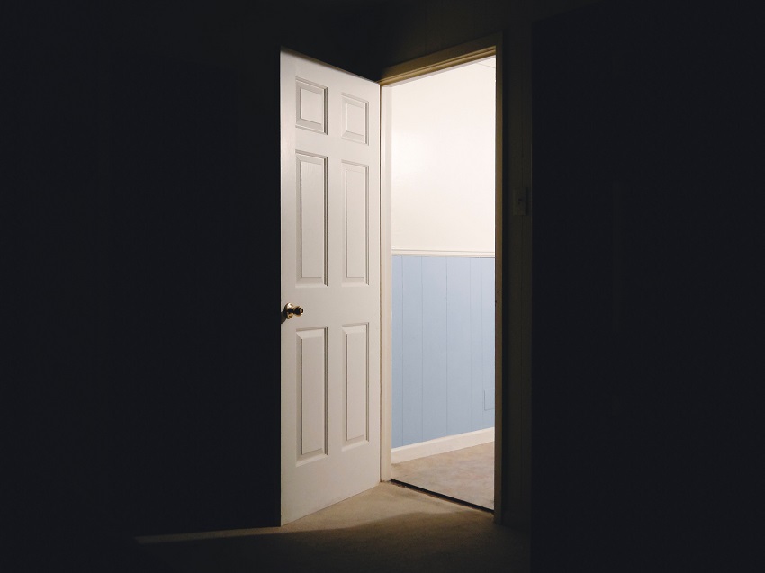 Open white door between garage and interior of Parker, CO home