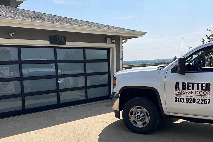 Full view aluminum garage door with frosted glass beside garage door service truck