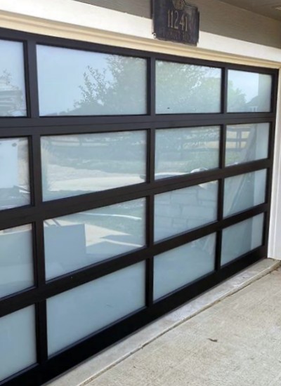 Full view garage door with frosted glass and white steel framing