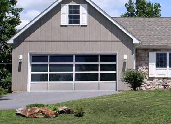 Full view aluminum garage door with frosted glass beside garage door service truck