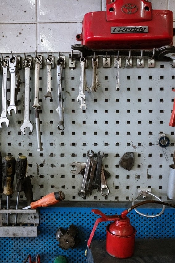 Wrenches, screwdrivers and WD40 in garage workstation